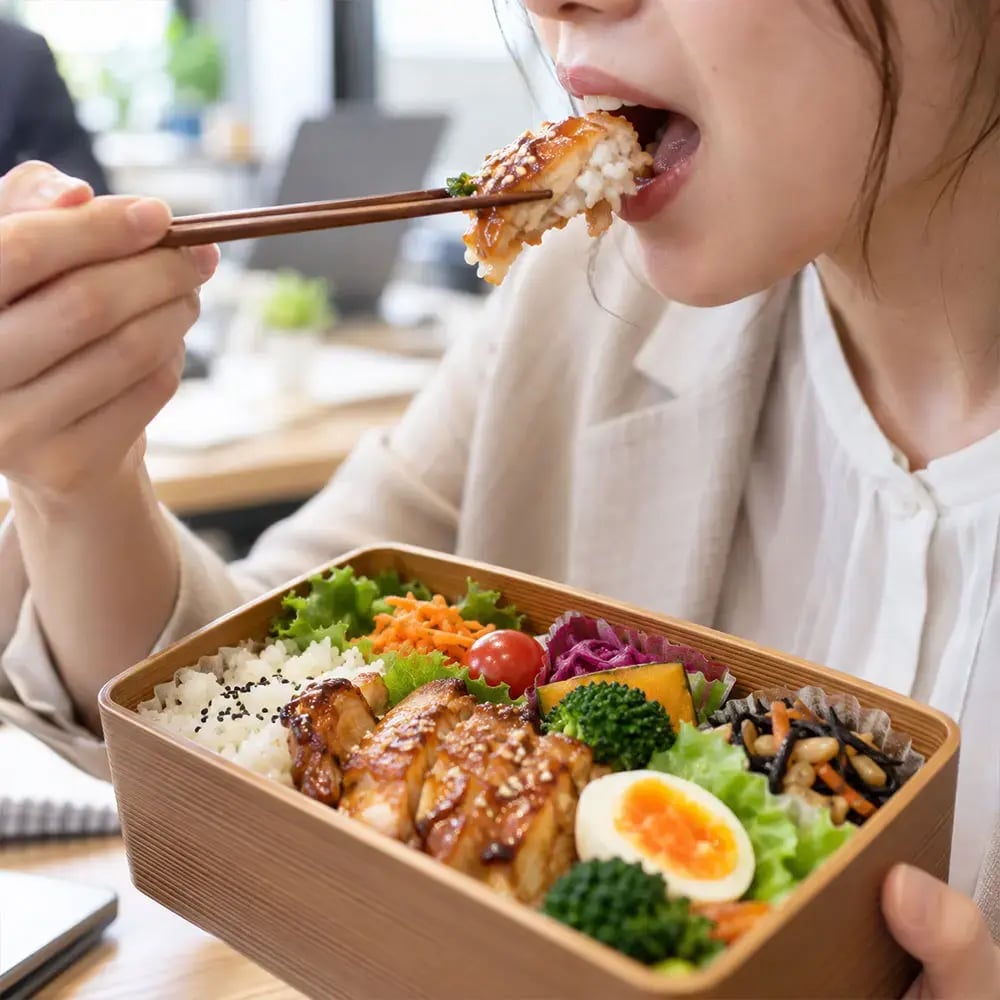 商務餐盒用餐情境,上班族近距離享用精緻餐盒與雞肉飯菜